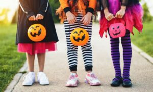 trick-or-treaters standing on the sidewalk 