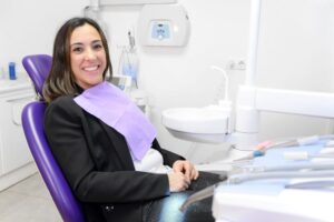 Happy dental patient smiling in treatment chair