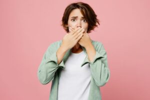 Concerned woman covering her mouth