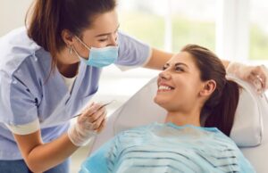 Happy patient smiling at dental team member