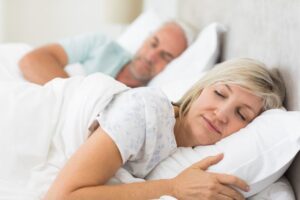 Mature couple sleeping peacefully in bed